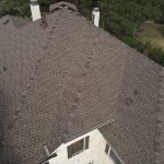 An aerial view of a shingle roof on a house