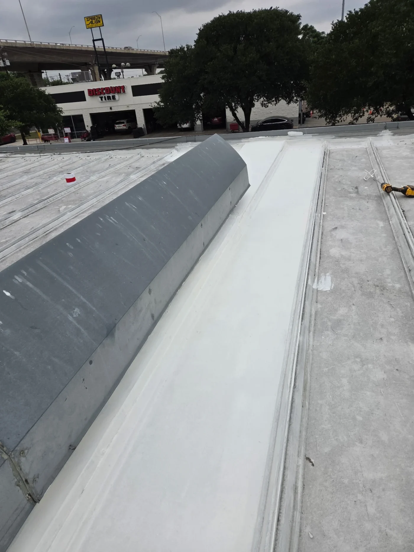 A close-up view of a TPO roof on a commercial street.