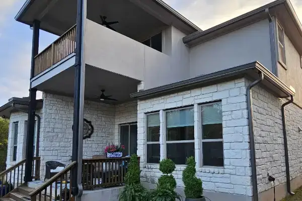 Wolfpack Roofing & Exteriors | Gutter Installation & Gutter Guards | Austin, TX Exterior austin home with new gutters by wolfpack roofing & exteriors