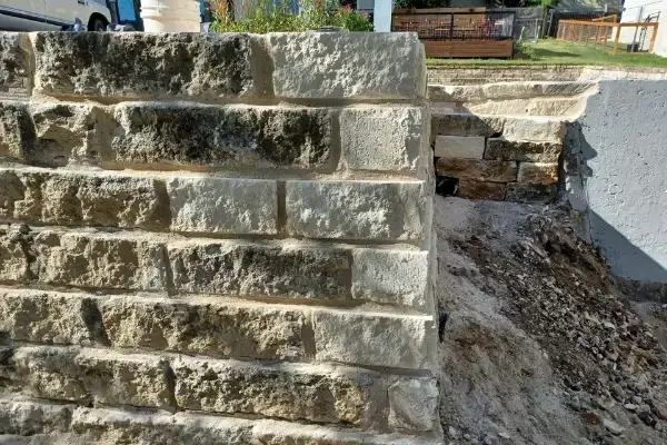 Wolfpack Roofing & Exteriors| Masonry Repair in Austin, TX Stone, brick wall repaired by wolfpack roofing & exteriors in austin, texas