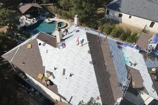 Wolfpack Roofing & Exteriors | GAF Roof Replacements & Repairs | Austin, TX Reroof by wolfpack roofing & exteriors during installation aeriel shot in austin texas